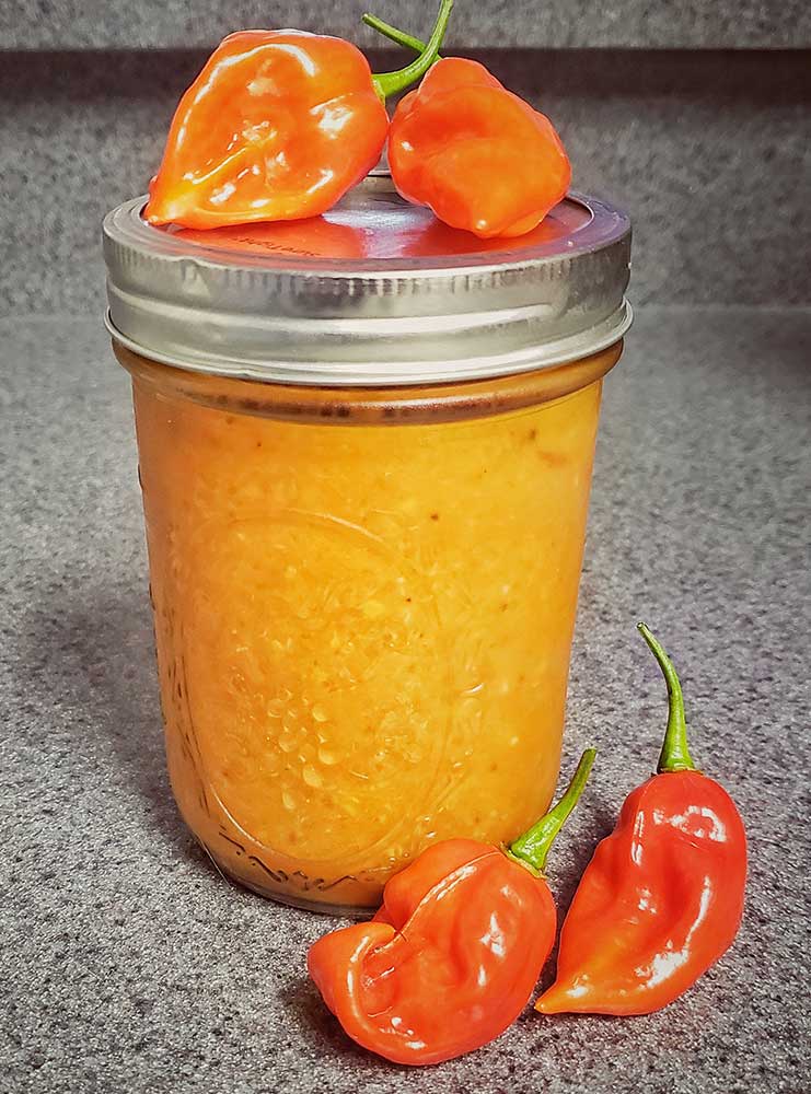 A mason jar filled with hot sauce.