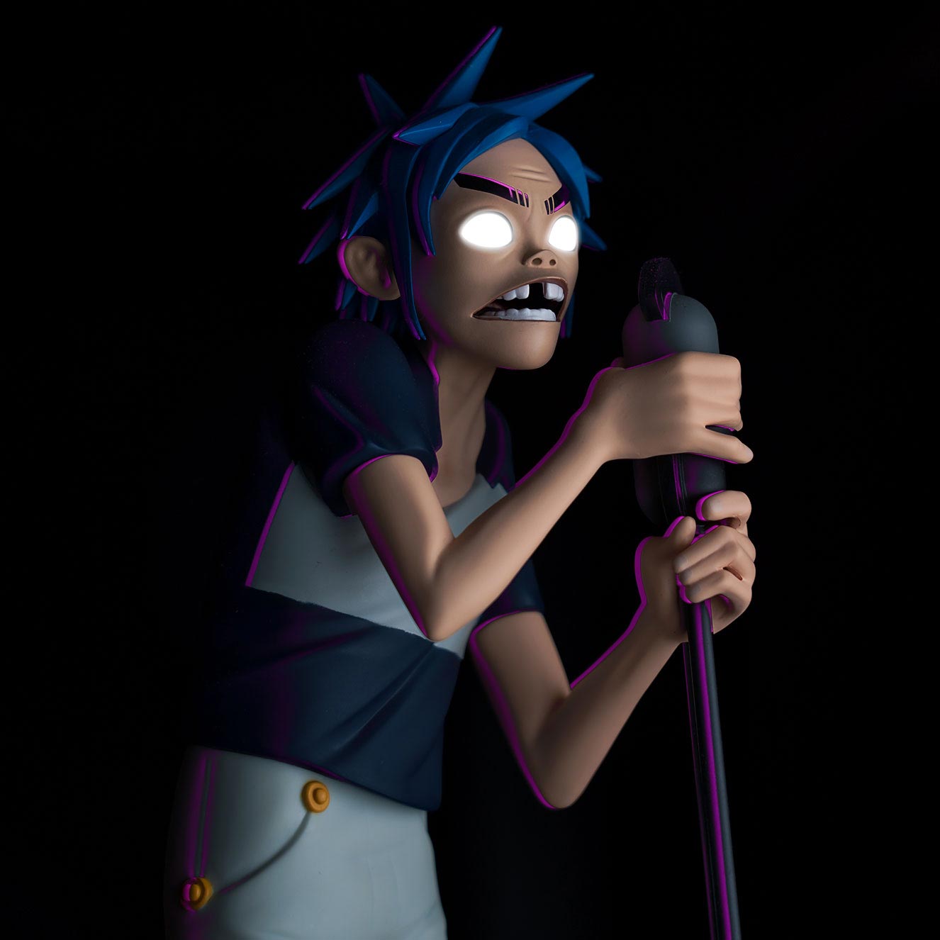 A statue of 2D from the Gorillaz on a black background.