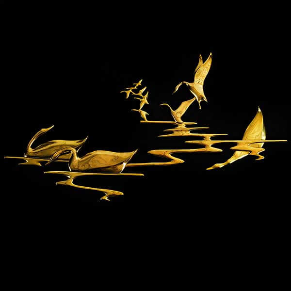 Product photo of metallic gold wall hang depicting swans on water.