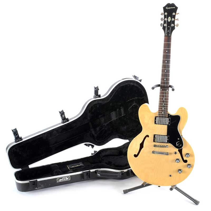 Product photo of tan guitar on a white background.