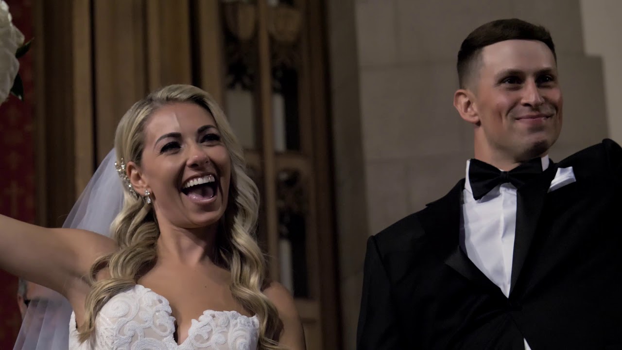 A bride and groom happily stand together.